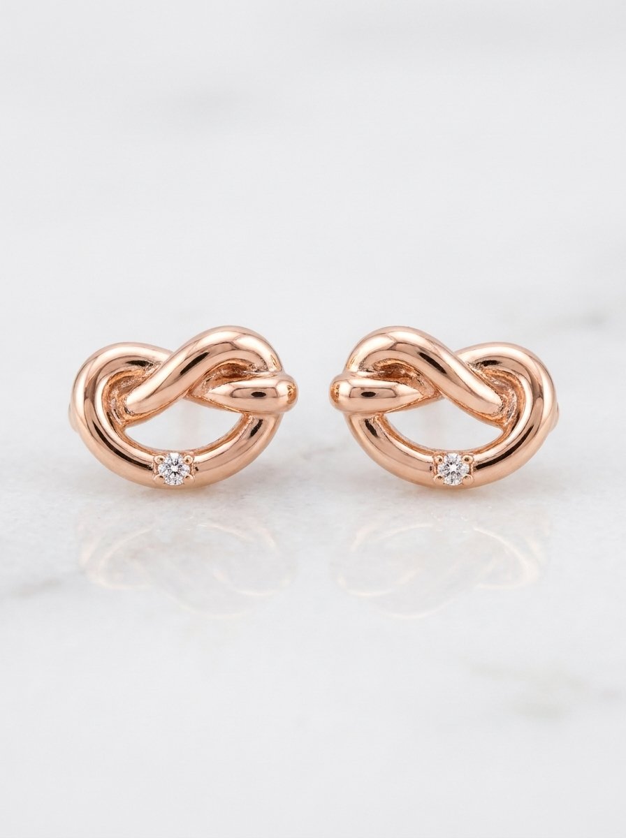 Orecchini oro rosa nodo con diamantino bianco ct. 0,01 G-SI au gr. 1,6